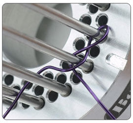 Wire being wrapped around jig pegs